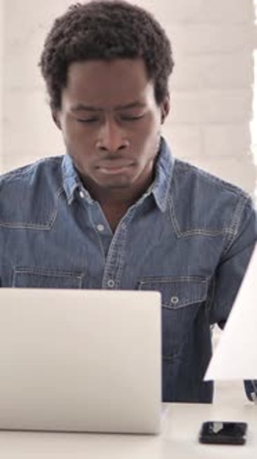 African Man Doing Paperwork in Office, vertical video