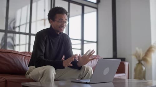 Young Adult Having Video Call on Laptop