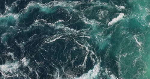 Blue waves of water of the river and the sea meet each other during high tide and low tide.