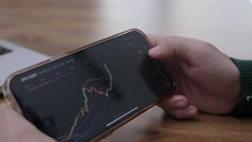 Closeup Trader is Checking Bitcoin Price Chart on Smartphone Cryptocurrency Exchange Market App