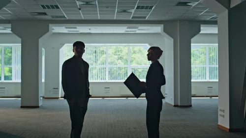 Partners Silhouettes Making Deal at Empty Hall Colleagues Handshake Together