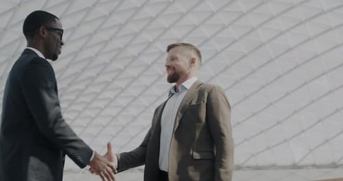 Businesspeople Partners Meeting in Airport Shaking Hands and Talking Developing Cooperation