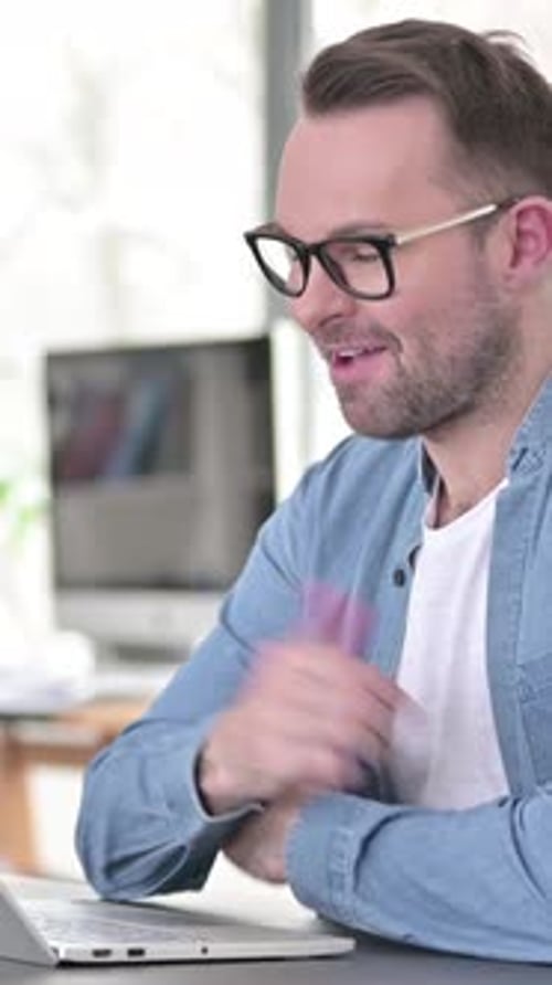 Man Waving During Video Call From Home Office
