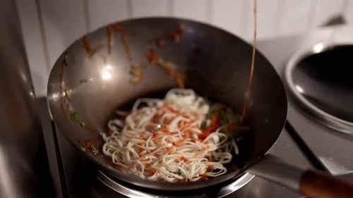 Wok and Chinese Noodles with Traditional Asian Sauce Closeup View Inside Traditional Restaurant