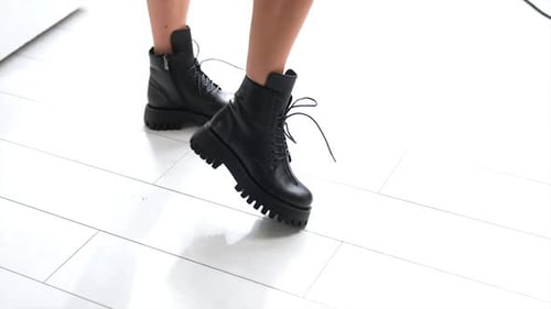 Stylish Woman Black Boots Close Up on White Tile