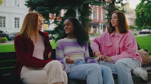 Friends Chatting on a Bench in the Park