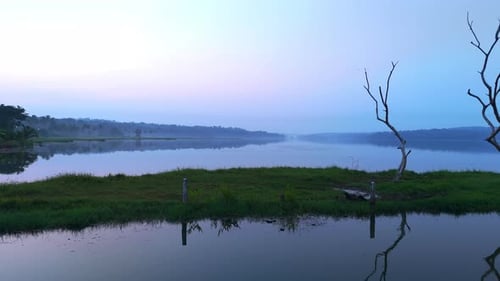 Morning calm lake , before sun lake reflecting the atmospheric effects of the sky and surrounded by