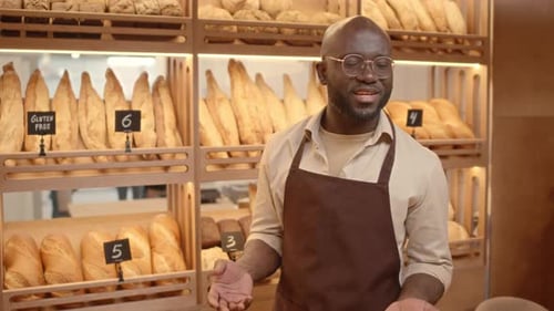 Black Man Selling Bread at Bakery