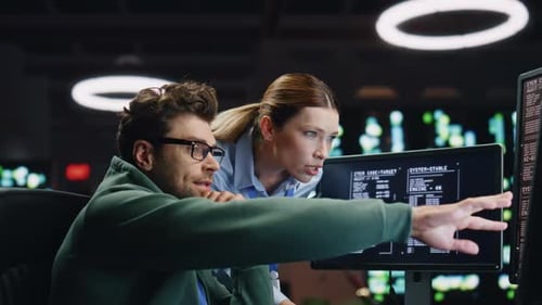 Programmers Couple Working Together in Dark Room Closeup Analysts Discussing