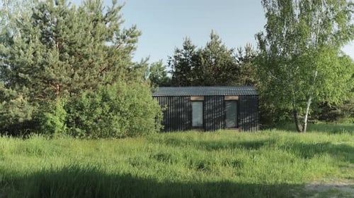 Tiny Cabin House in Morning Forest Green Grass Sun Rays on Top of the Trees Cozy Wooden House Slow