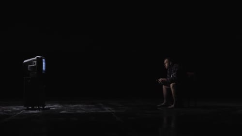 Man Gaming in a Dark Room