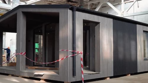 A New Wooden Modular Prefabricated House Inside an Industrial Building