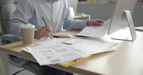 Man with Coffee and Documents Working in the Office