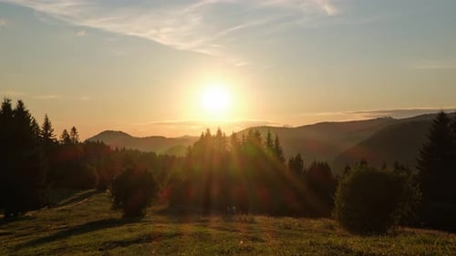 Timelapse of a Golden Sunset Over a Mountain Forest