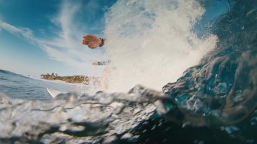 Surfer Rides the Ocean Wave in the Maldives In Water and Underwater View of the Surfer on the Wave