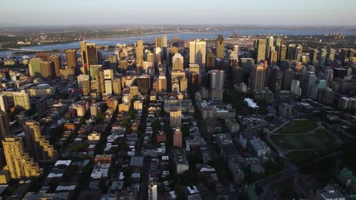 Panoramic drone shot of the Centre-Ville district of Montreal city, sundown in Canada