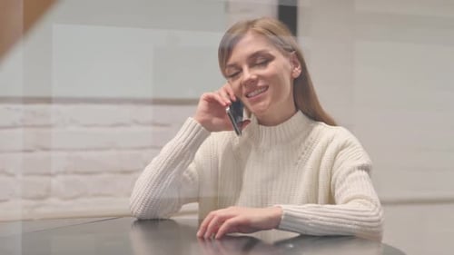 Woman Talking on Cell Phone in Modern Home
