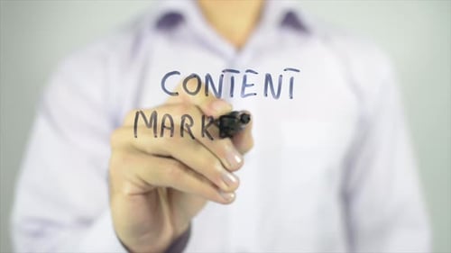 Hand Writes Content Marketing on Glass Board