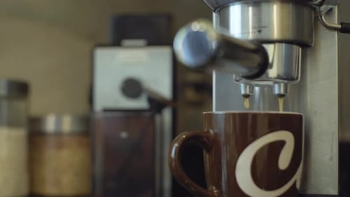 Coffe being poured unto a mug