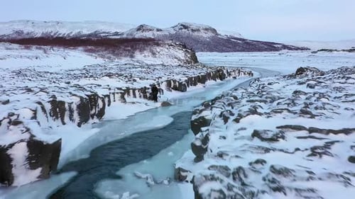 Aerial View of Snowy River Landscape in Winter