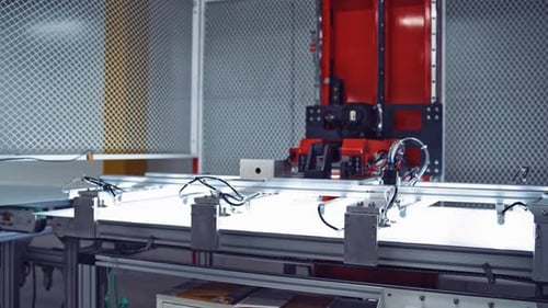 Production of solar panels. Automated equipment at work inside the modern industrial plant.