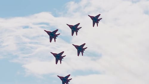 Five Fighter Jets Flying Together in Formation