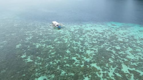 Motorboat Floating Near a Tropical Coral Reef