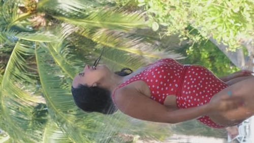 Young Woman Taking Shower on a Beach