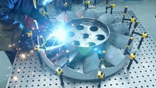 Workman Making Welding of Channel Blades of Huge Fan. Man Making Welding