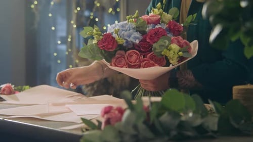 Florist Arranging Beautiful Bouquet of Roses and Hydrangeas