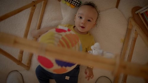 Happy Baby Playing on Playmat at Home