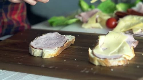 Preparing open sandwich with cheese and ham