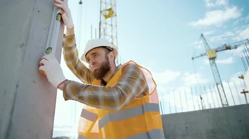 Construction Worker Checking Level on Job Site