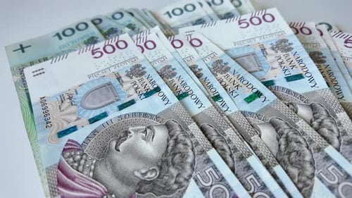 Panning view polish money, 500 and 100 zlotys banknotes are lying.