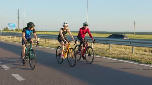 Active People in Safety Helmets Cycling on Fresh Air