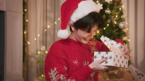 Excited Young Adult Opening Christmas Gift