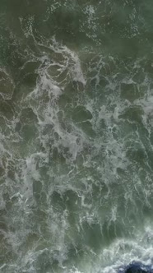 Vertical Video of Ocean Waves Rolling On Shoreline