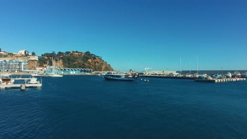 Luxury yachts docked in a sunny spanish marina bay on a summer vacation day