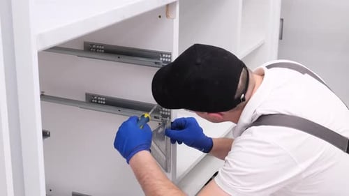 A Professional Master During the Installation of Kitchen Furniture