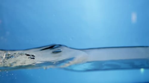 Crystal clear water ripples against a white background, emphasizing purity and freshness, perfect fo