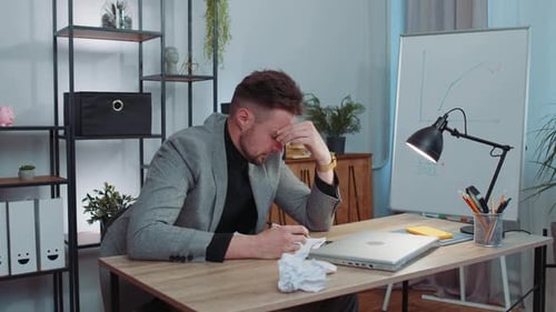 Angry Furious Man Working at Home Office Throwing Crumpled Paper Having Nervous Breakdown at Work
