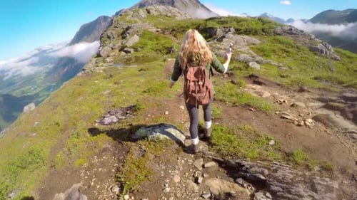 4k video footage of an unrecognisable woman hiking through the mountains in Norway