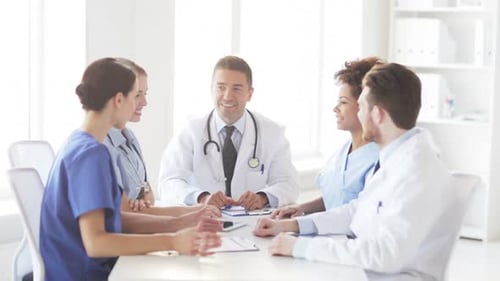 Happy doctors high five in hospital teamwork meeting concept