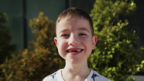 Boy Smiling Happily Outdoors in Close Up