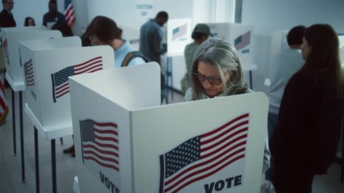 Elderly Woman Votes in Booth in Polling Station Office