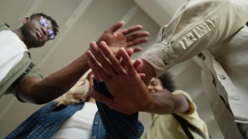 Bottom View Hands Stacking Together Indoors Unity Four Cheerful Smiling Multiracial Students Stack