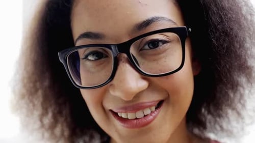 Smiling woman with glasses looking at camera