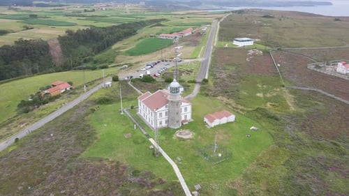 Aerial shot of Cabo Peñas, Asturias, Spain. Lighthouse next to cliff and atlantic ocean.