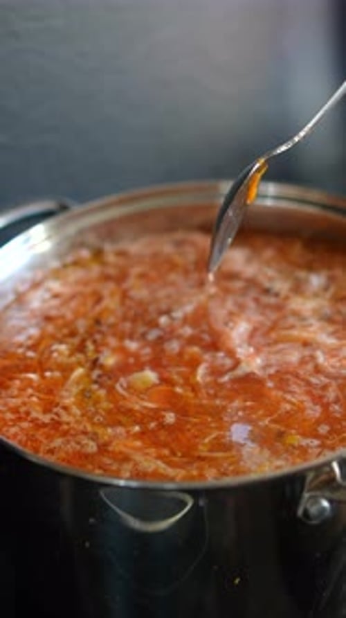 Stirring Hearty Soup in a Cooking Pot