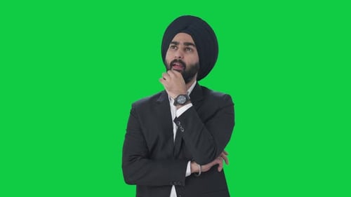 Confused Sikh Indian businessman thinking Green screen